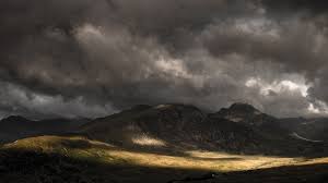 dark clouds over mountains