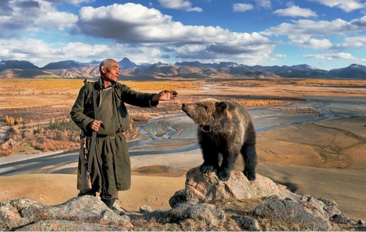 Mongolian man with bear and mountains